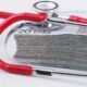a stethoscope resting on top of a stack of money