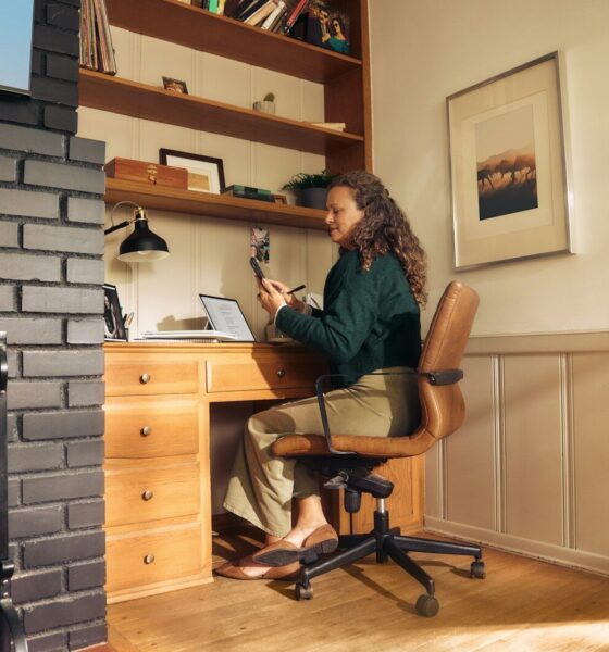 Woman working at a desk in a cozy home office.