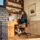 Woman working at a desk in a cozy home office.