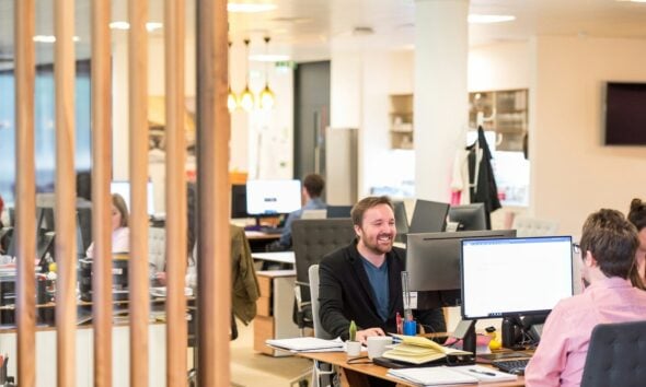 a man sitting at a desk in an office