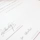 A university degree certificate with a red seal and two signatures