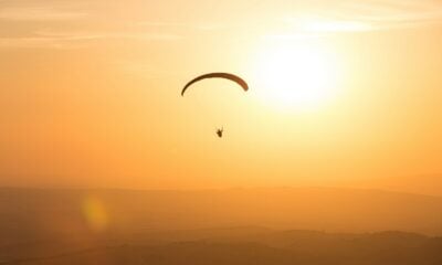 person parachuting during golden hour