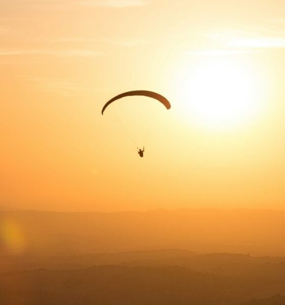 person parachuting during golden hour