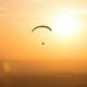 person parachuting during golden hour