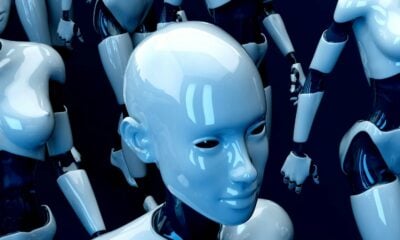 A group of glossy white humanoid robots against a dark blue background