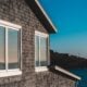 brown brick wall near white framed glass window