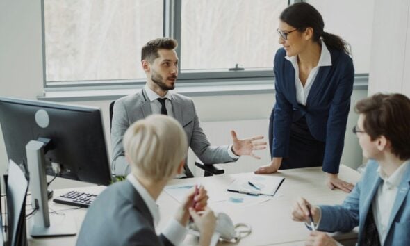 Business professionals collaborating in a modern office meeting