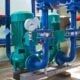 a group of pipes and valves in a room