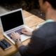 man in front of laptop computer in shallow focus photography