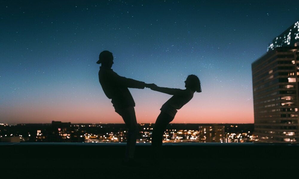 silhouette of man jumping on the field during night time