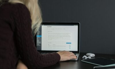 woman in black sweater using macbook pro
