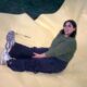 Smiling woman sitting on a large yellow inflatable structure