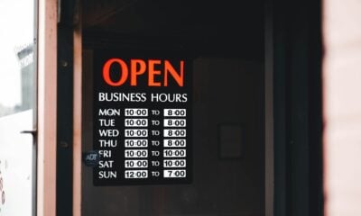 a sign on a door that says open business hours