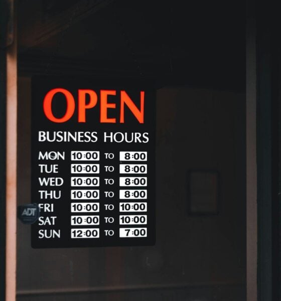 a sign on a door that says open business hours