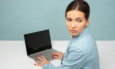woman using laptop and looking side