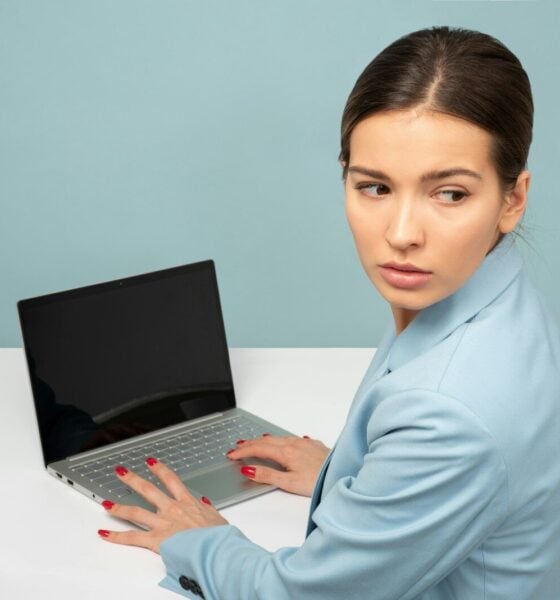 woman using laptop and looking side