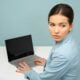 woman using laptop and looking side