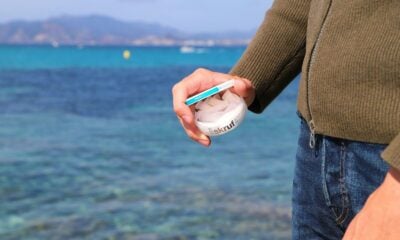 a man is holding a toothbrush in his hand