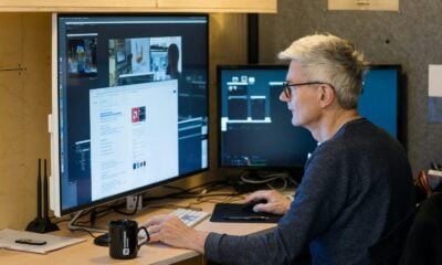 a man sitting in front of a computer monitor