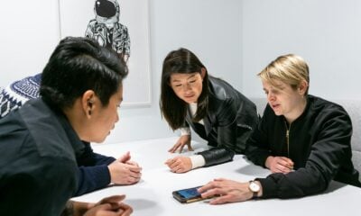people in a meeting in a white room discussing app development