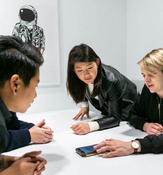 people in a meeting in a white room discussing app development
