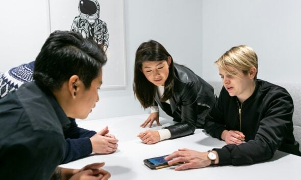 people in a meeting in a white room discussing app development