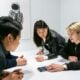 people in a meeting in a white room discussing app development