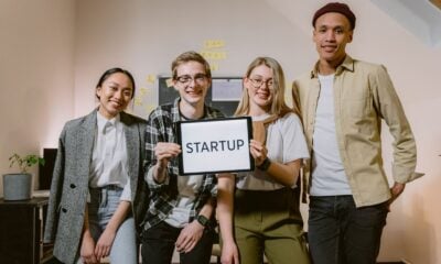 A diverse group of smiling young professionals showcasing teamwork in a startup environment.