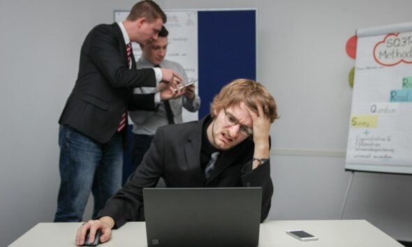 A man sitting in front of a laptop computer