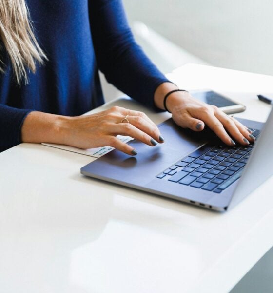 woman in blue long sleeve shirt using macbook pro