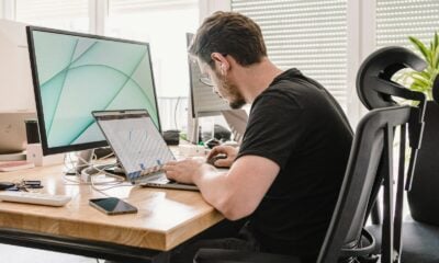 a man sitting at a desk working on a computer