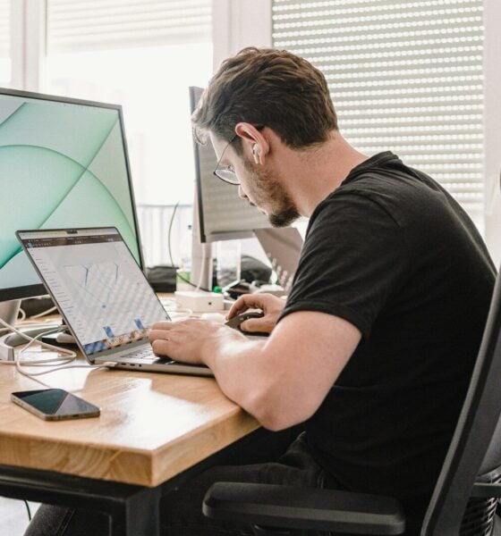 a man sitting at a desk working on a computer