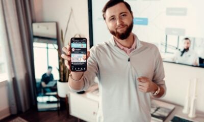 a man holding up a smart phone in his hand