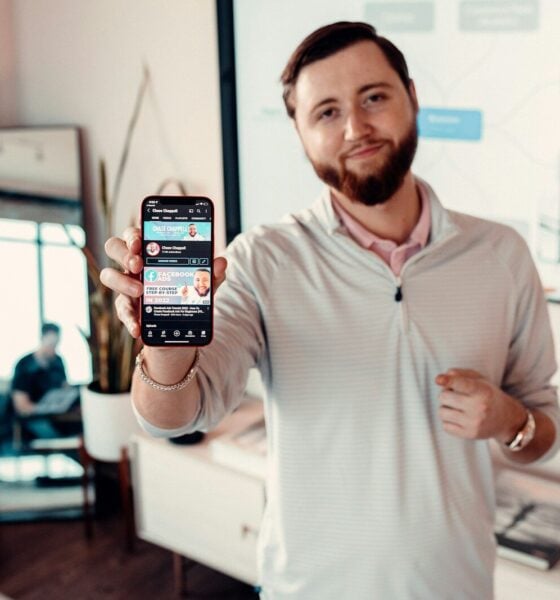 a man holding up a smart phone in his hand