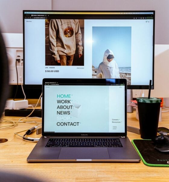 a laptop computer sitting on top of a wooden desk