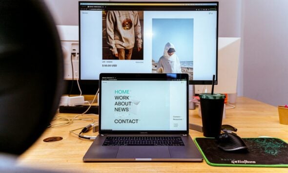 a laptop computer sitting on top of a wooden desk