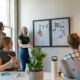 A group of people in a sunlit office during a collaborative workspace meeting