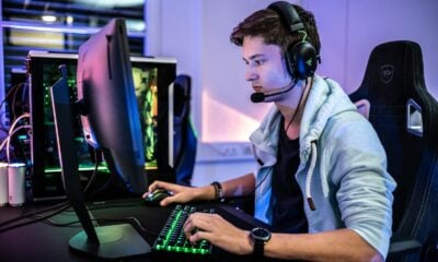 a man wearing a headset sitting in front of a computer