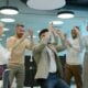 Diverse group of colleagues celebrating success in office