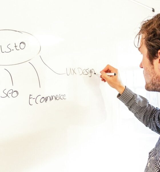 a man writing on a whiteboard