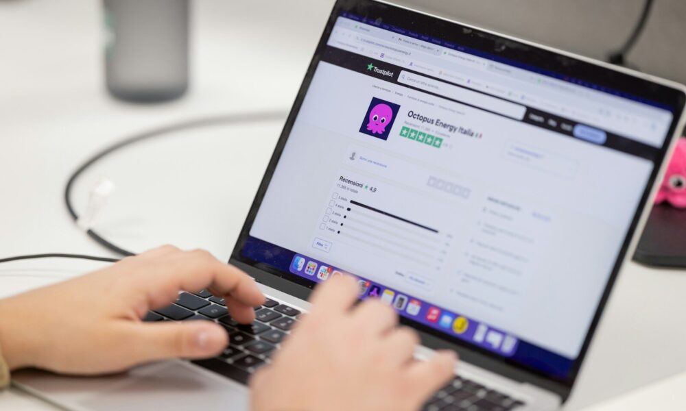Person typing on a laptop computer screen
