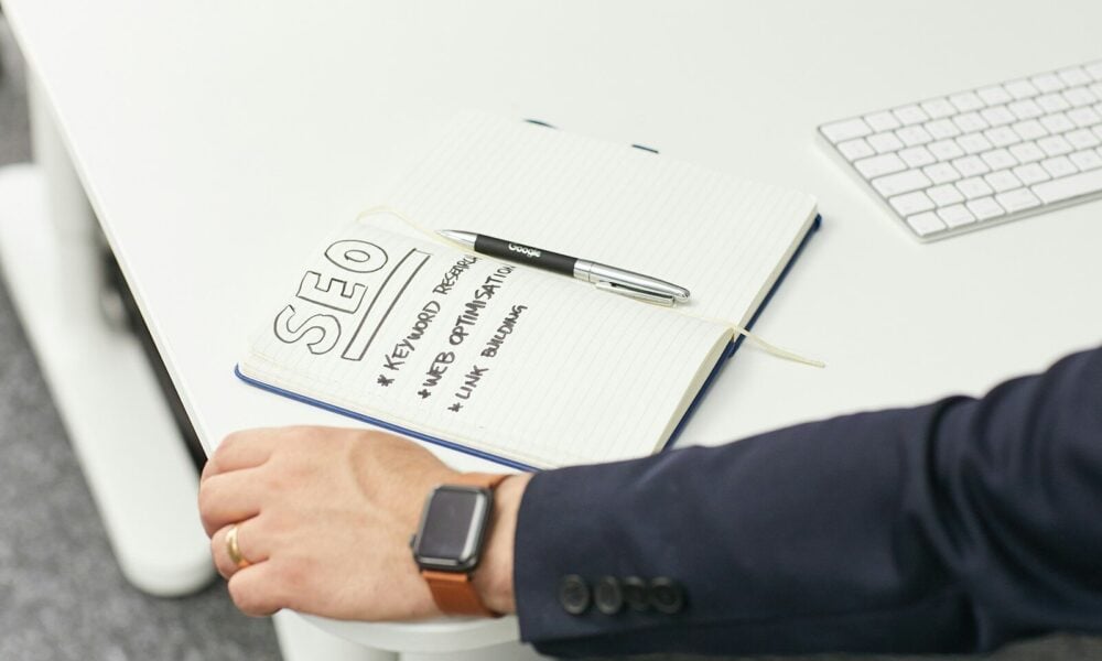 a person writing on a piece of paper