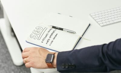 a person writing on a piece of paper