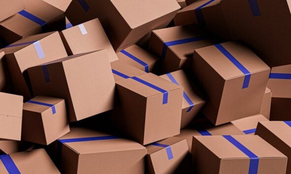 A large pile of brown cardboard boxes with blue tape