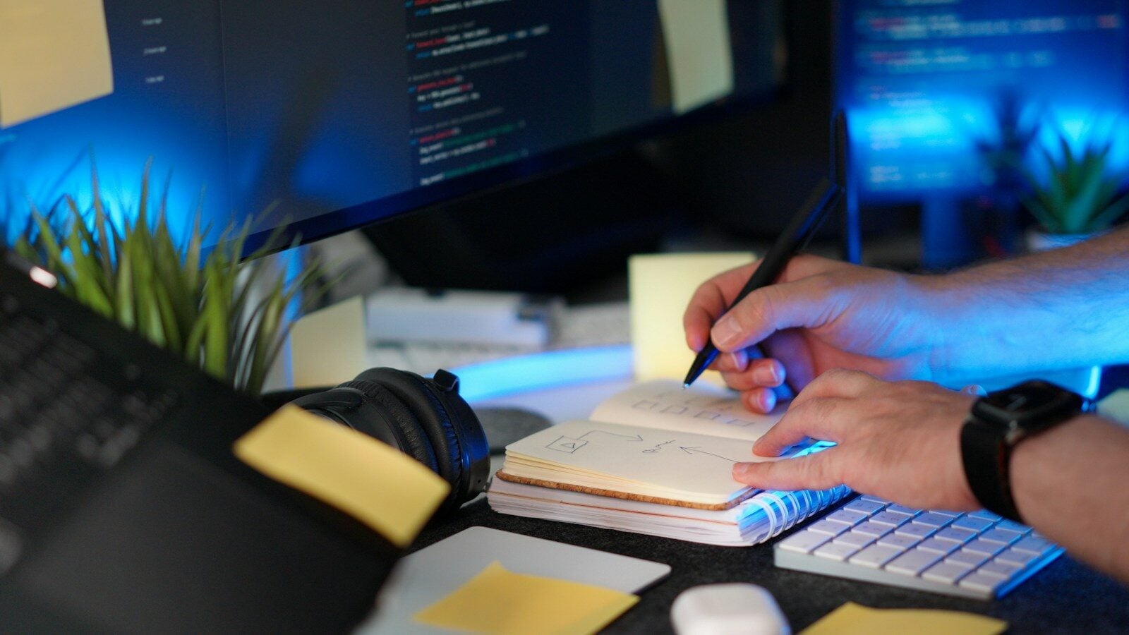A person codes while taking notes