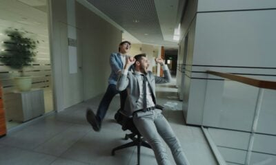 Two businessmen having fun in office hallway