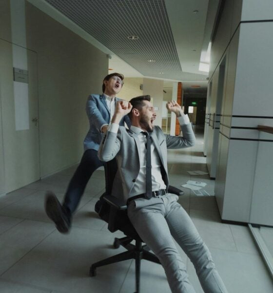 Two businessmen having fun in office hallway