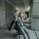Two businessmen having fun in office hallway