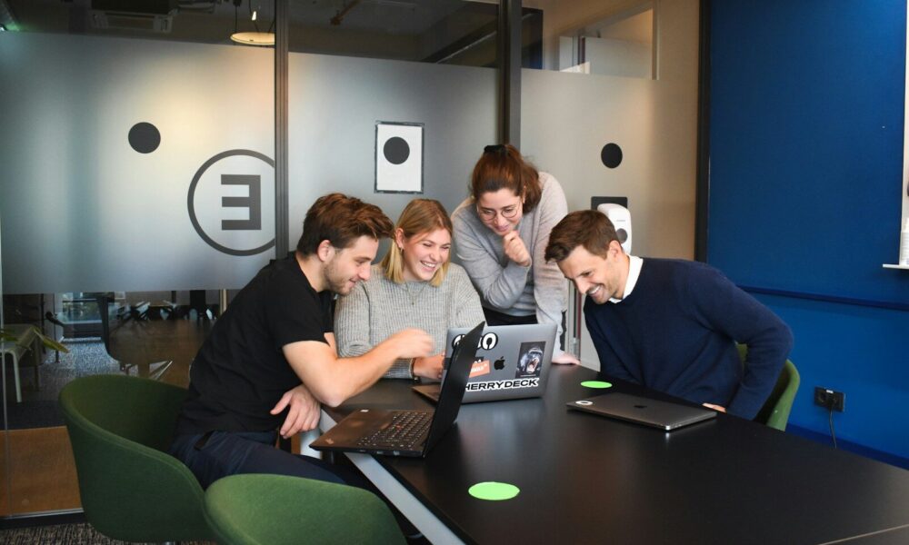people sitting on chair in front of laptop computers