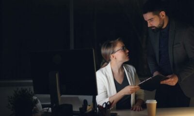 Two colleagues working late in a dimly lit office